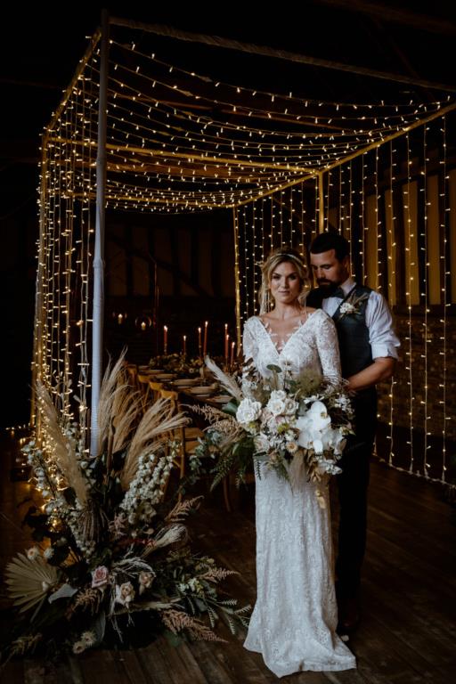Fall Wedding Inspiration - Fair Lights hanging above a Bride and Groom - Fall Wedding Decor