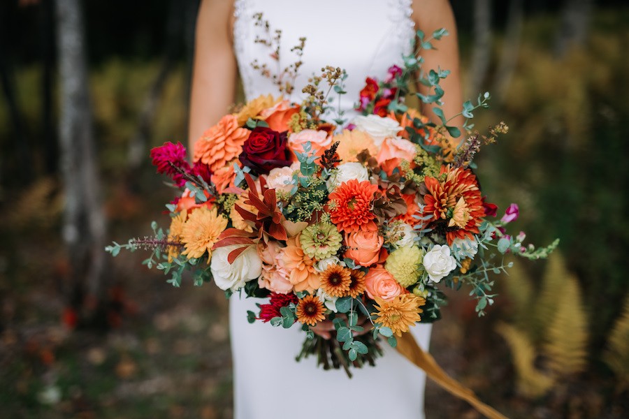 Fall Wedding Inspiration - bride holding a rich colored flower bouquet